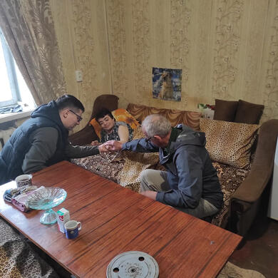 Praying with a shut-in after delivering medicine &amp; food